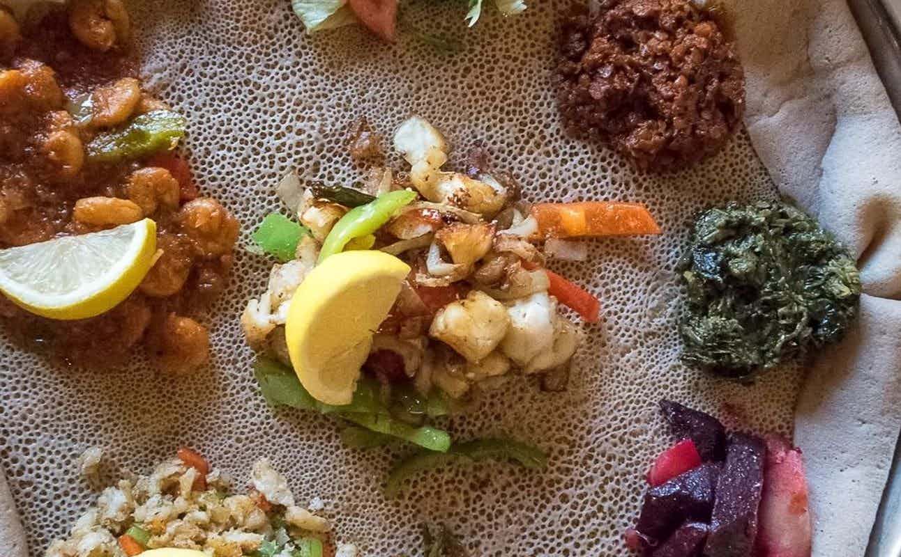 Enjoy Ethiopian, Vegan Options, Vegetarian options, Restaurant, Private Dining, Street Parking, Highchairs available, Free Wifi, Table service, Non-smoking, $$, Groups and Families cuisine at Asmara Bella in Northern Quarter, Manchester