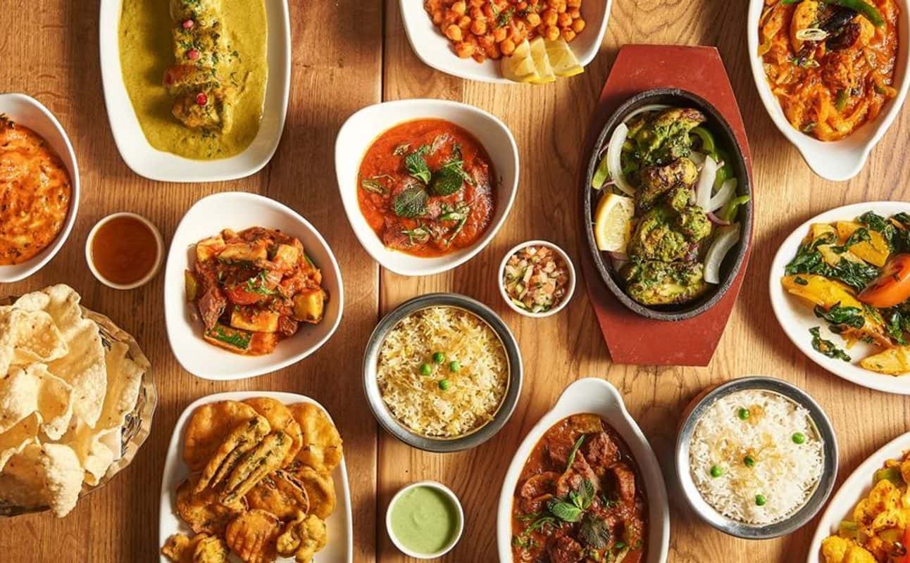 Enjoy Indian, Asian, Vegetarian options, Hotel restaurant, $$, Live music, Families and Groups cuisine at Holy Cow Restaurant & Bar in Putney, London